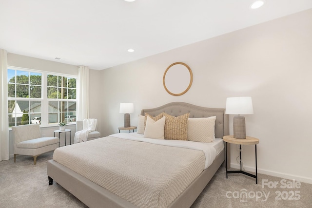 bedroom with baseboards, recessed lighting, and light colored carpet