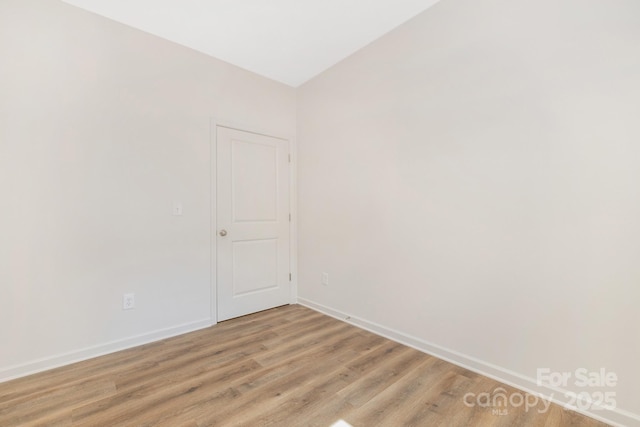 empty room featuring baseboards and wood finished floors