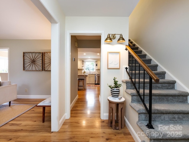 interior space with wood finished floors and baseboards