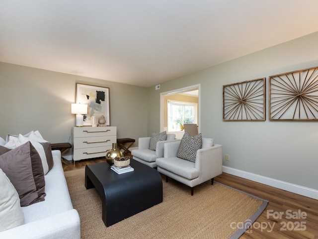 living room with baseboards and wood finished floors