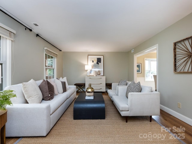 living room with baseboards and wood finished floors