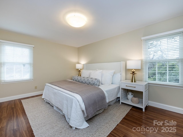 bedroom featuring baseboards and wood finished floors