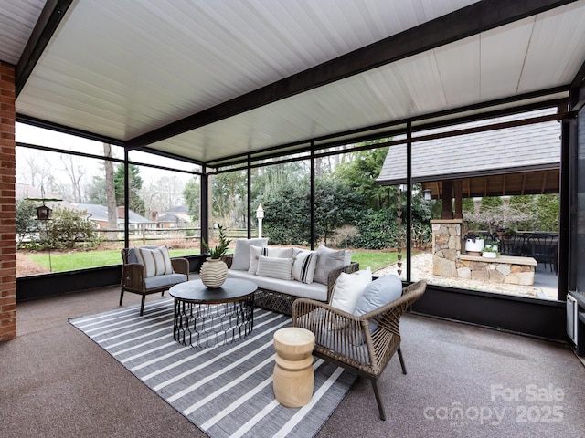 sunroom featuring beamed ceiling