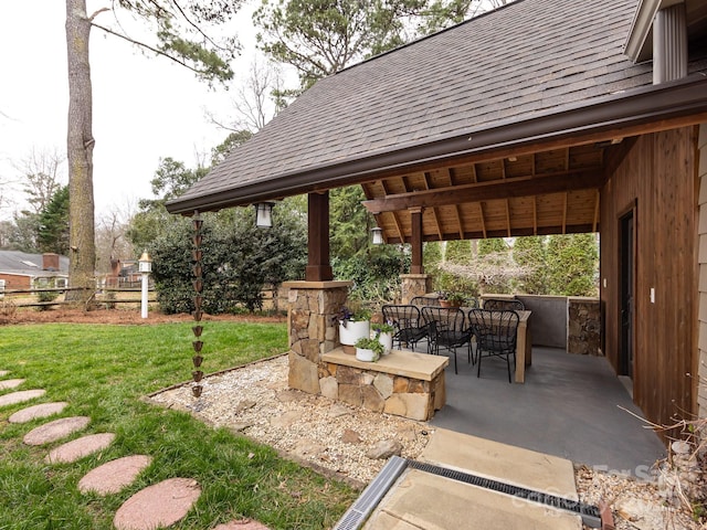 view of patio featuring outdoor dining space and fence