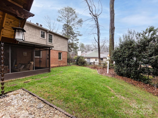 view of yard featuring a sunroom and fence