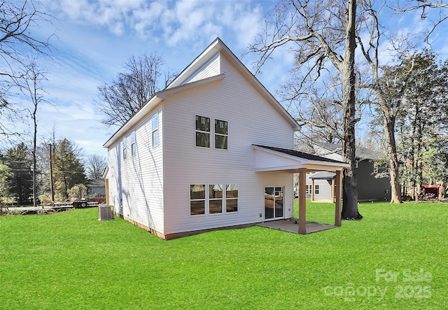 back of house featuring a patio, a yard, and central AC unit