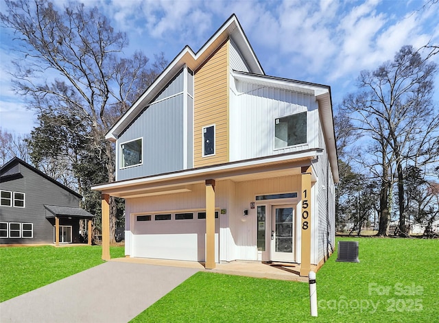 view of front of house with cooling unit, a garage, and a front yard