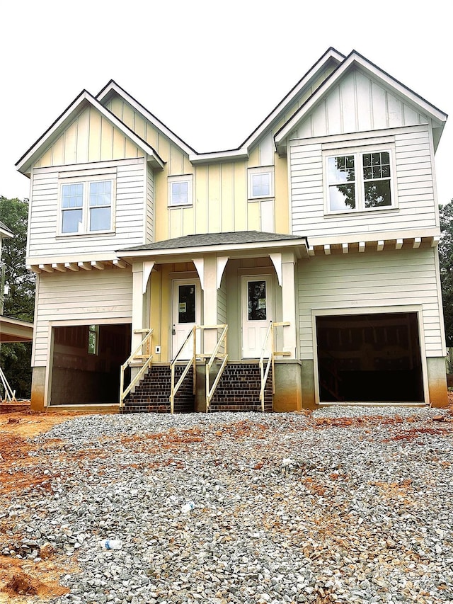 2526 Elkwood Cir, Charlotte, NC 28205 - craftsman house featuring an attached garage, driveway, board and batten siding, and covered porch