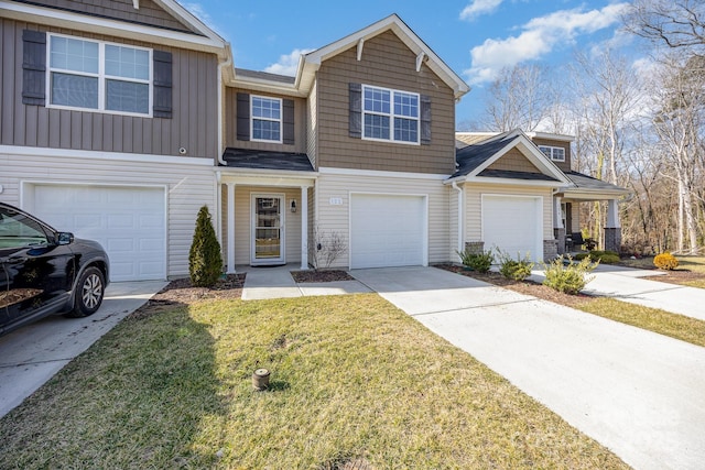 townhome / multi-family property with a garage and a front yard