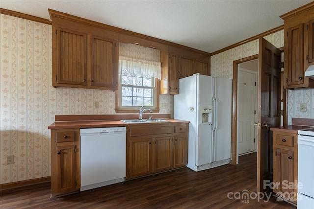 kitchen featuring dark hardwood / wood-style flooring, sink, white appliances, and crown molding