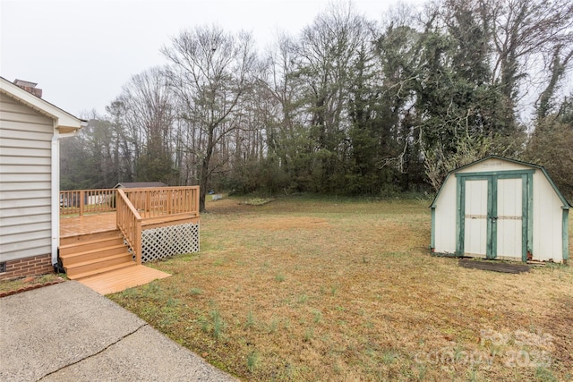 view of yard with a deck and a storage shed