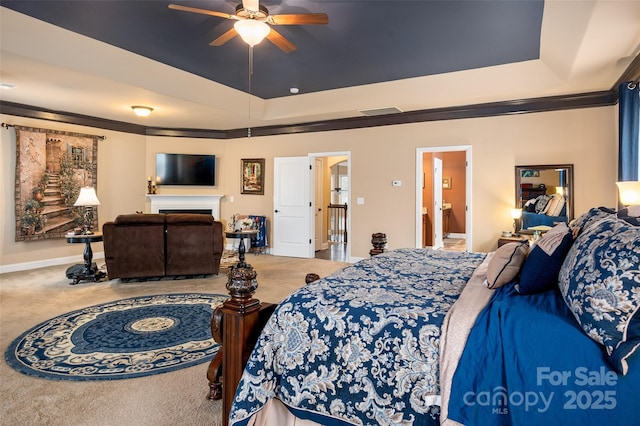 bedroom featuring crown molding, a raised ceiling, and carpet floors