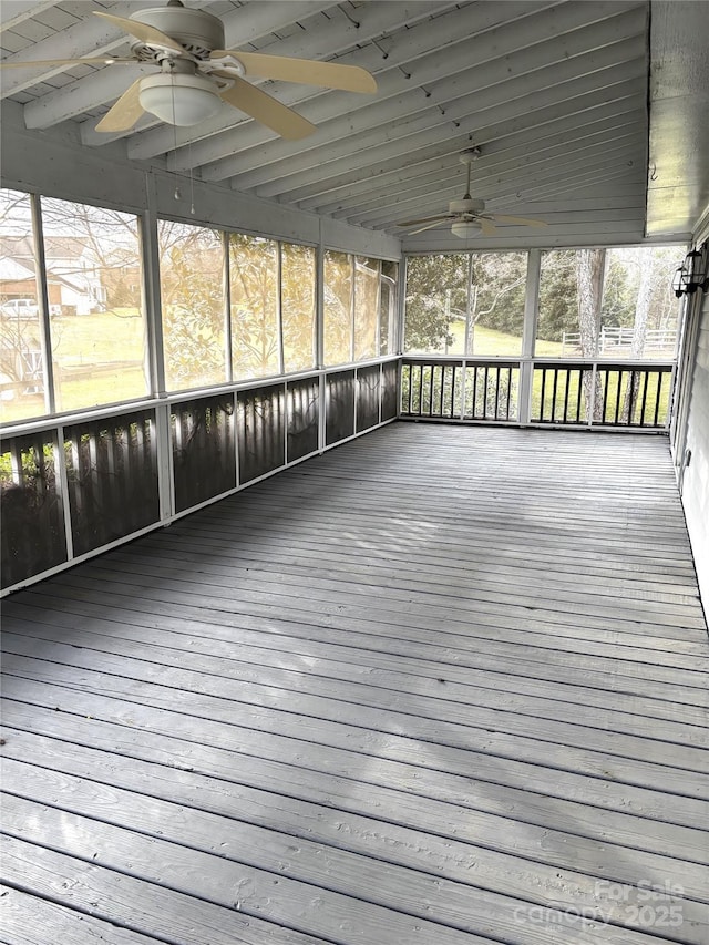 unfurnished sunroom featuring ceiling fan