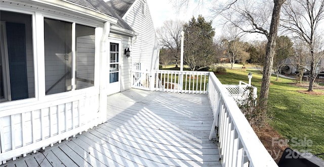 wooden deck featuring a yard