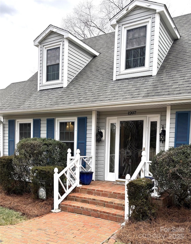 cape cod house with a shingled roof