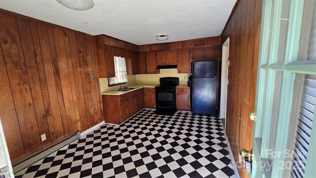 509 California Cir, York, SC 29745 - kitchen with sink, wooden walls, black appliances, and baseboard heating