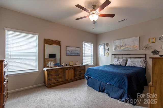 bedroom featuring light carpet, baseboards, visible vents, and a ceiling fan