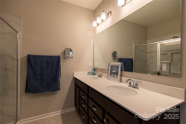 full bath with double vanity, tiled shower, and a sink