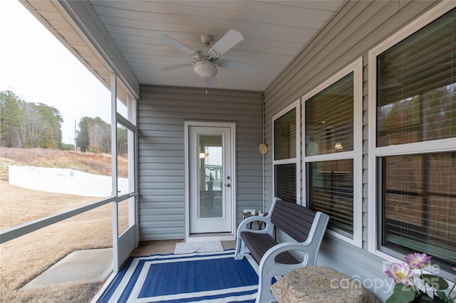 sunroom featuring a ceiling fan