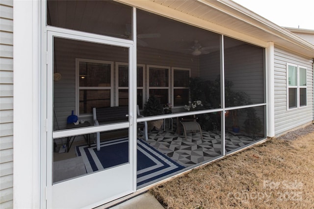 view of property exterior with a sunroom