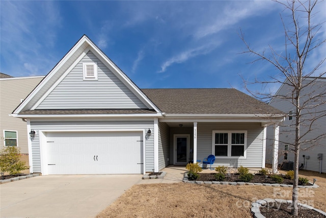 ranch-style home with a garage, covered porch, concrete driveway, and a shingled roof