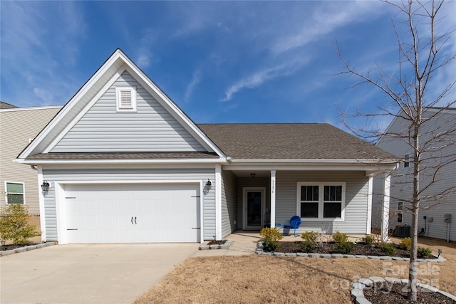3156 Pinehills Way, Mount Holly, NC 28120 - view of front facade featuring driveway, covered porch, roof with shingles, and a garage