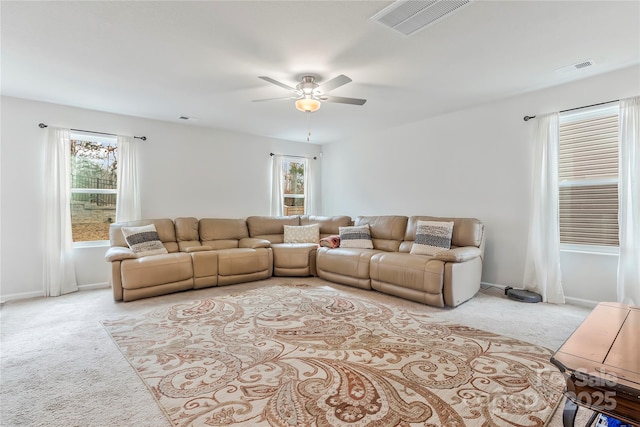 living room featuring light carpet and ceiling fan