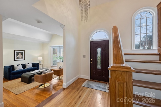 foyer entrance featuring lofted ceiling and light wood-type flooring