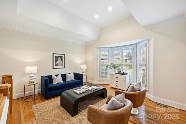 living room featuring crown molding and light wood-type flooring