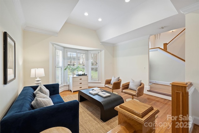 living room featuring ornamental molding and light wood-type flooring