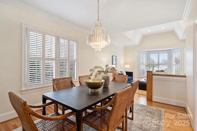 dining room featuring crown molding, a chandelier, and light hardwood / wood-style floors