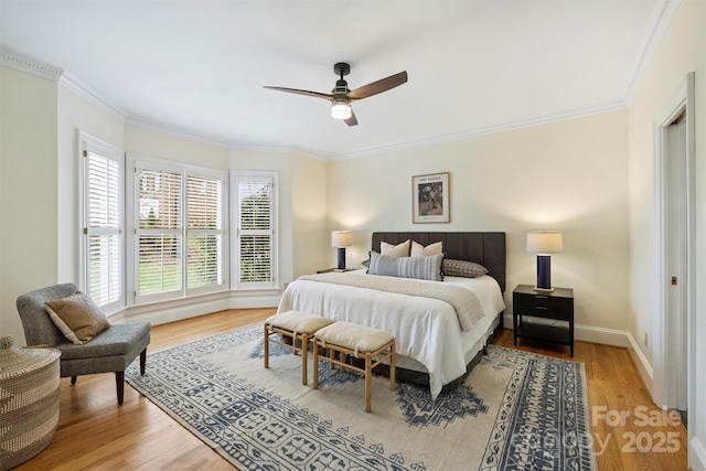 bedroom with ceiling fan, ornamental molding, and hardwood / wood-style floors