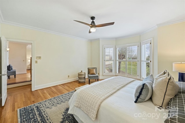 bedroom with hardwood / wood-style flooring, ceiling fan, and crown molding