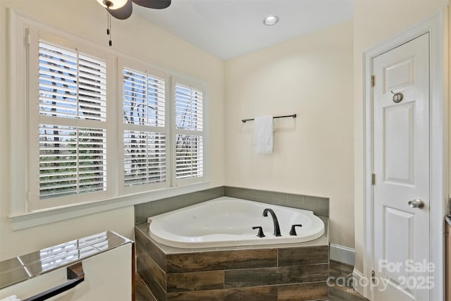 bathroom featuring tiled tub