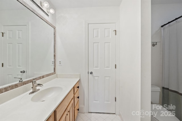 bathroom with vanity, walk in shower, tile patterned floors, and toilet