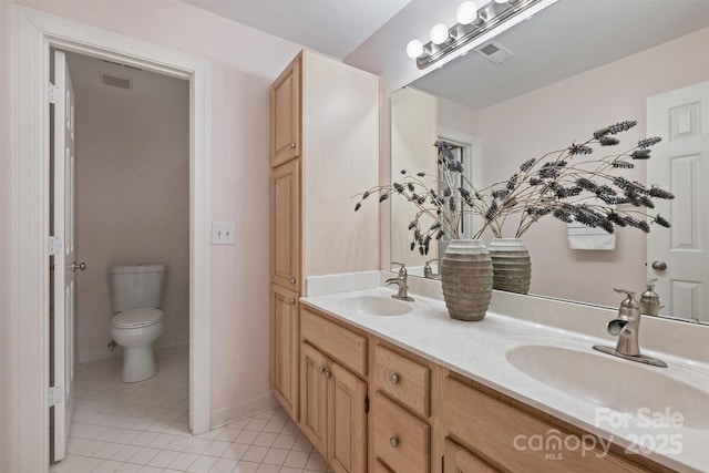 bathroom featuring vanity, toilet, and tile patterned flooring