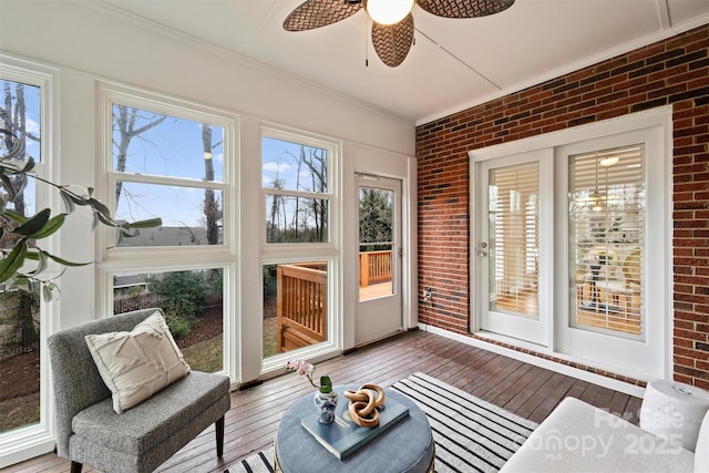 sunroom / solarium featuring ceiling fan