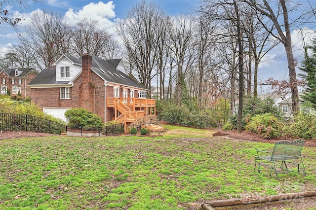 view of yard with a garage and a deck