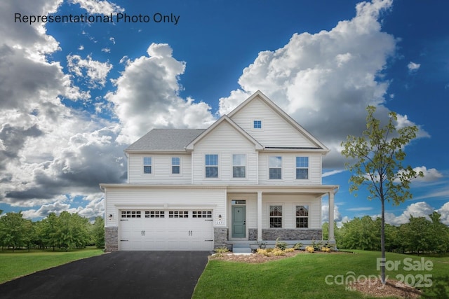 view of front of house with a garage and a front yard