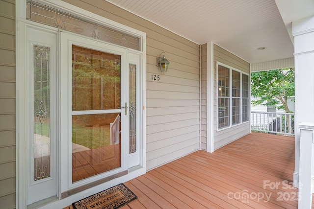 view of exterior entry with covered porch