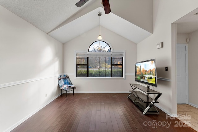 interior space featuring lofted ceiling, dark hardwood / wood-style floors, and ceiling fan