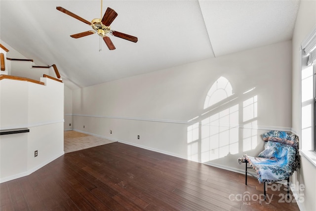 unfurnished living room with lofted ceiling, hardwood / wood-style floors, and ceiling fan