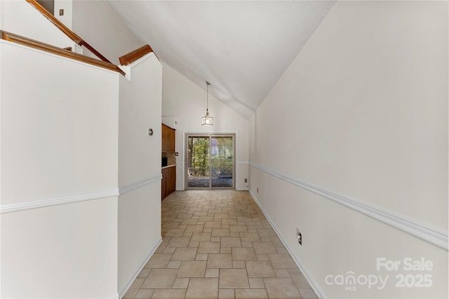 hallway with high vaulted ceiling