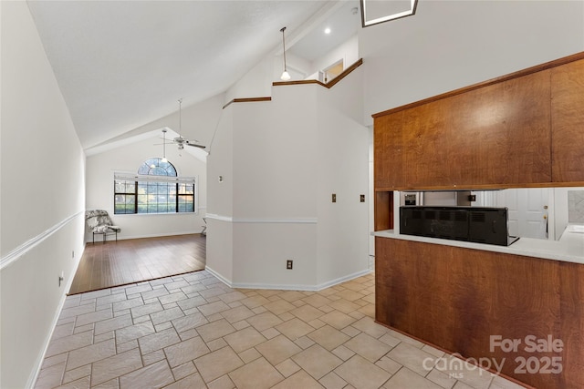 kitchen featuring high vaulted ceiling, pendant lighting, and ceiling fan