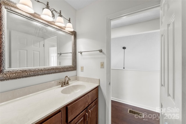 bathroom featuring vanity and hardwood / wood-style flooring