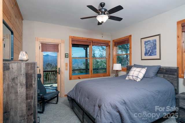 bedroom with ceiling fan, light colored carpet, and access to outside