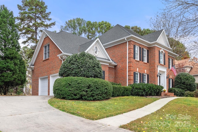 view of front property with a garage and a front lawn