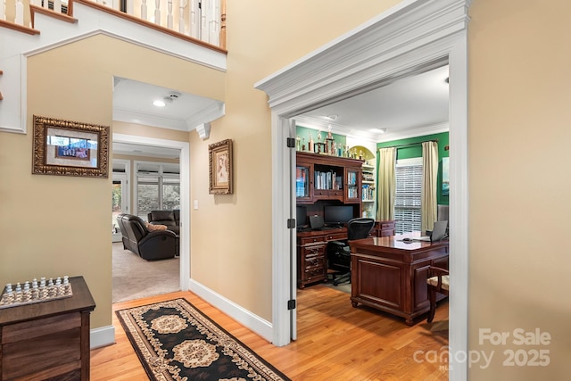 office space featuring ornamental molding and light hardwood / wood-style floors