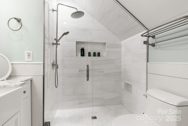 bathroom featuring vanity, toilet, and a shower with shower door