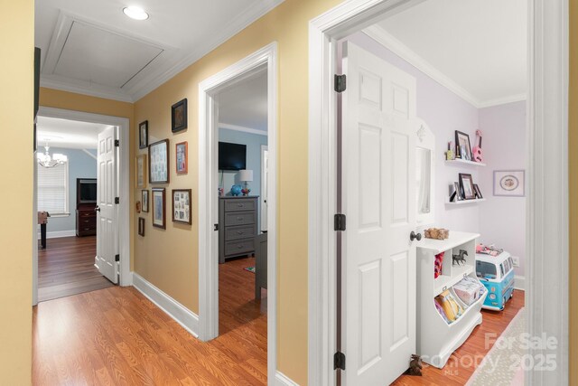 corridor featuring wood-type flooring and ornamental molding